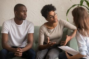 young couple discussing birth control options with a doctor